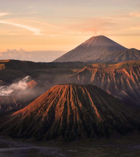 Mount Bromo with a landscape of Mount Semeru in the backgroud, a mountains in the Tengger Caldera.